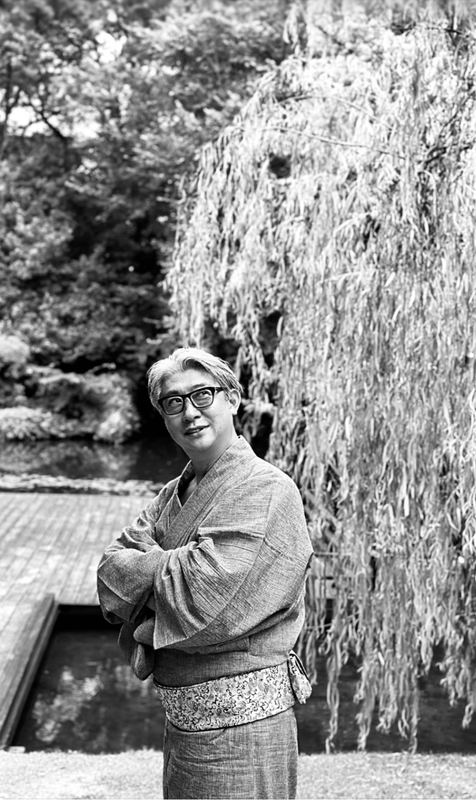 柳の下に立つ着物姿の西田理一郎（モノクロ）