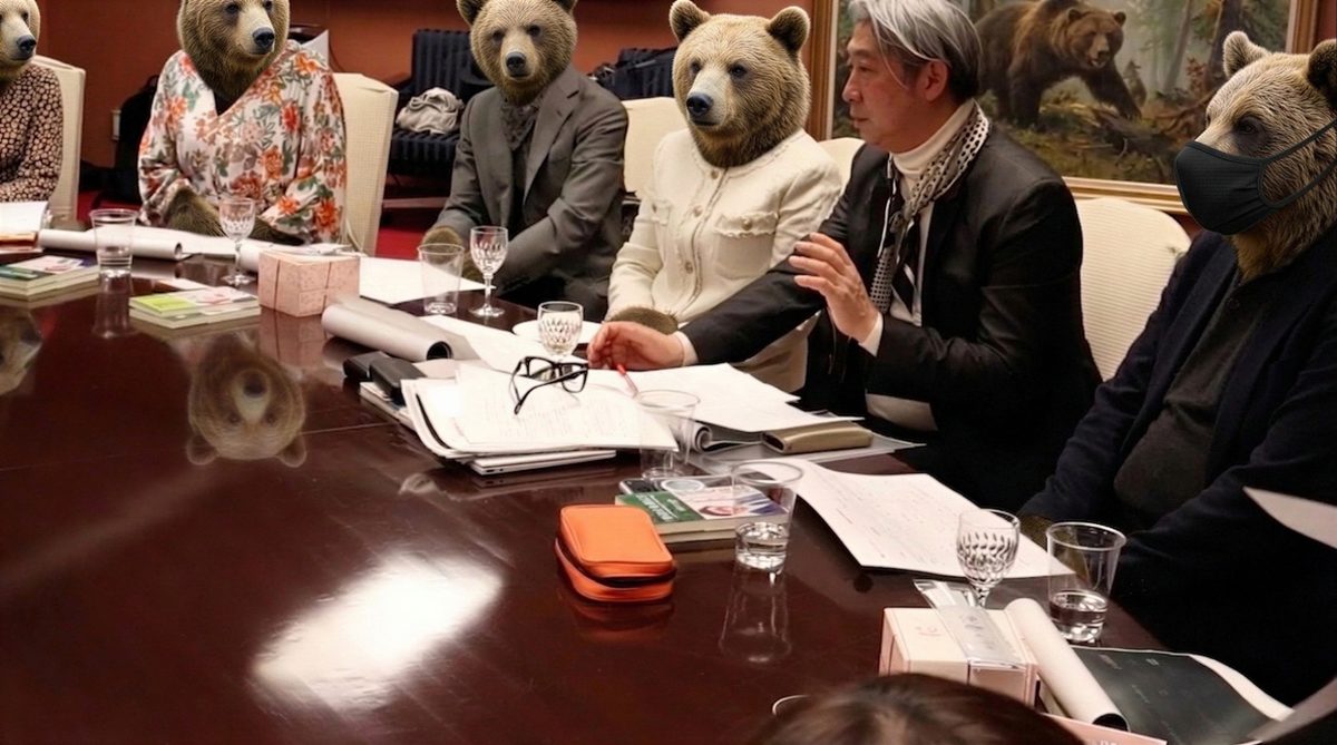 会議で話す西田理一郎（参加者をクマに見立てた合成画像）